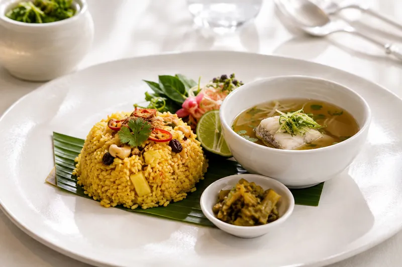 Turmeric pineapple fried rice with a clear Tom-Mee fish consommé and pickled mustard greens